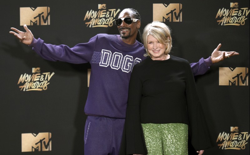 In this May 7, 2017 file photo, Snoop Dogg, left, and Martha Stewart pose in the press room at the MTV Movie and TV Awards in Los Angeles. The domestic diva who brought us hemp yarn is now partnering with Canada's Canopy Growth Corp. to develop new products containing CBD, a compound derived from hemp and marijuana that doesn't cause a high. Stewart's tie-up with Canopy may not be a surprise to her fans. In 2015, she baked brownies on "The Martha Stewart Show" with marijuana aficionado Snoop Dogg, and hinted that Snoop could add a little weed if he wanted to. (Photo by Richard Shotwell/Invision/AP, File)