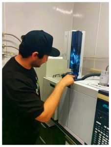 Chief Science Officer (CSO) Kevin Koby preparing the liquid injection autosampler to measure the volatile compounds in a cannabis extract.