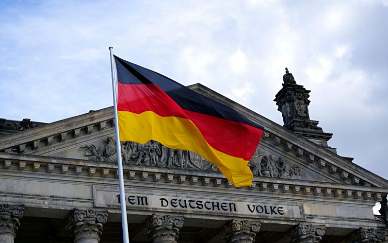 German flag blows in the wind on a flagpole