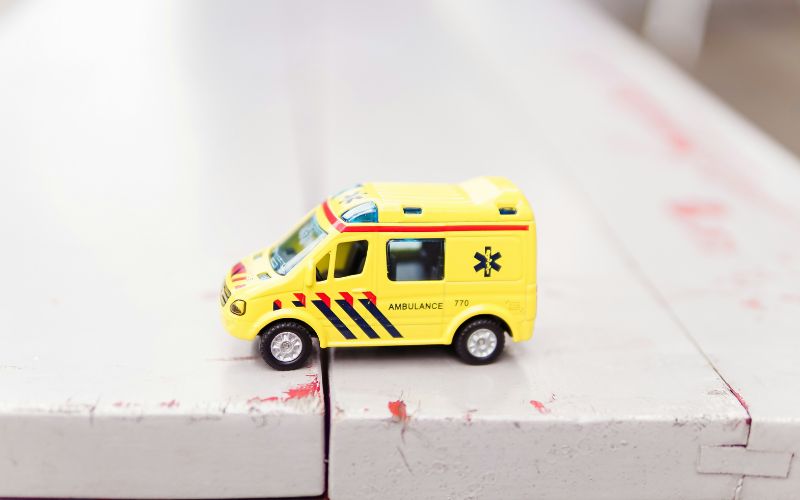 Toy ambulance close up on a wood bench