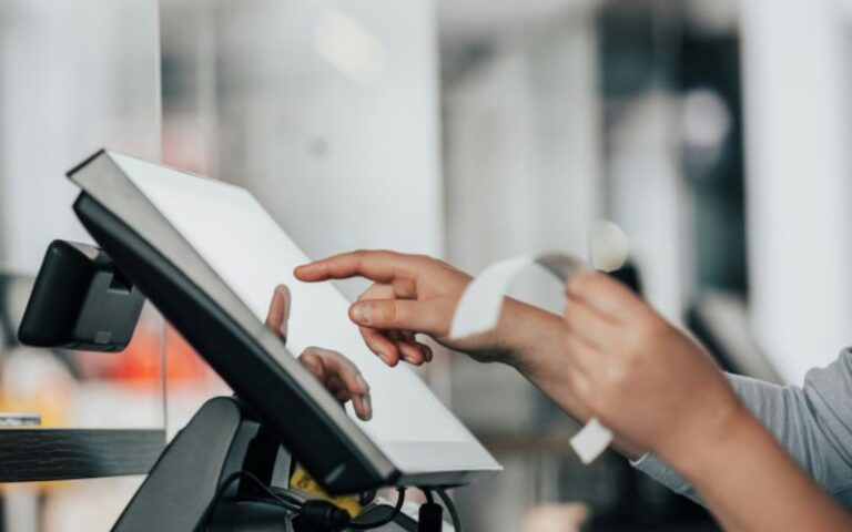 A sales person rings up a receipt at the point of sale system