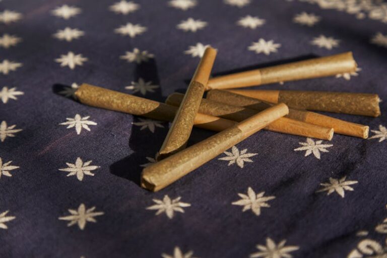 pre-rolled cannabis joint on starred background.