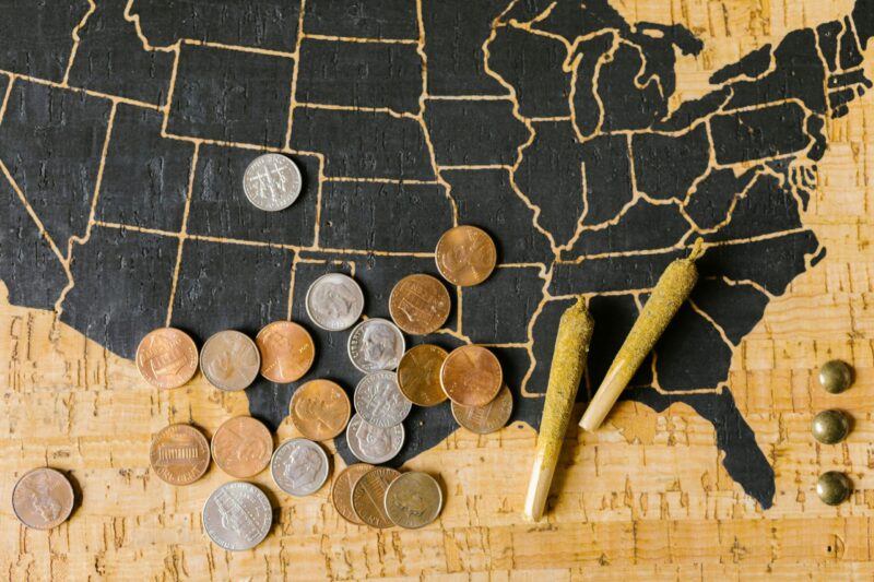 money, pre-rolled cannabis, and a map of the united states